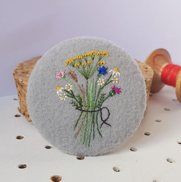 grey floral badge