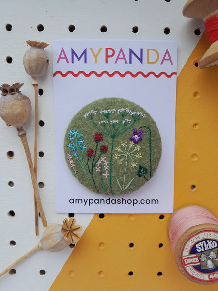 green wild flower badge