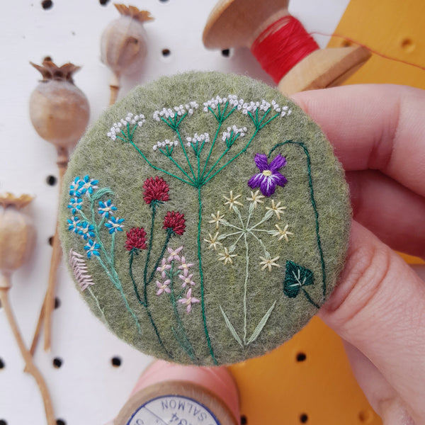 green wild flower badge