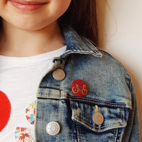 burgundy bike badge - being worn