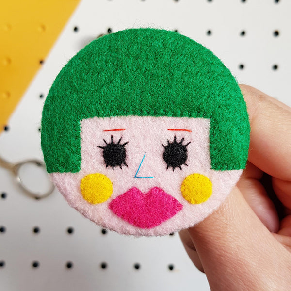 felt face badge with green bobbed hair