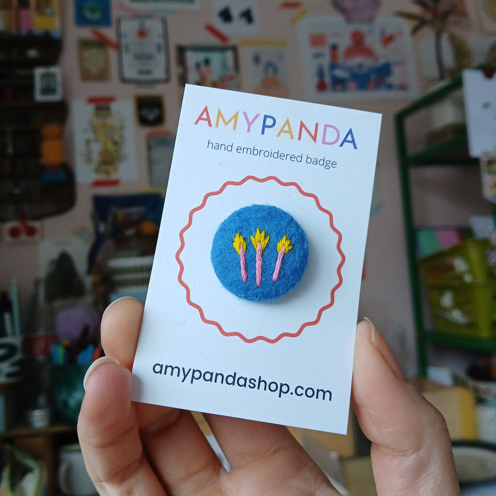 Rhubarb badge on blue - amypanda