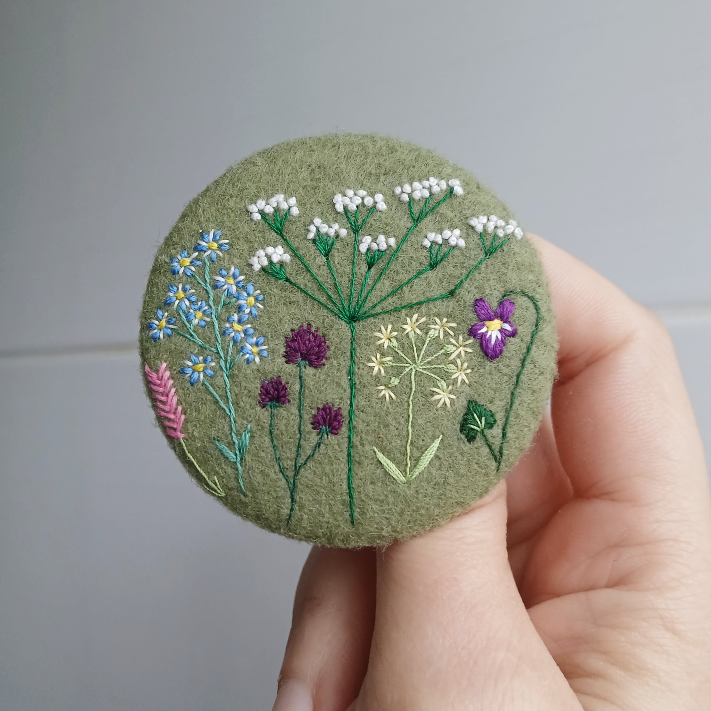 green wild flower badge