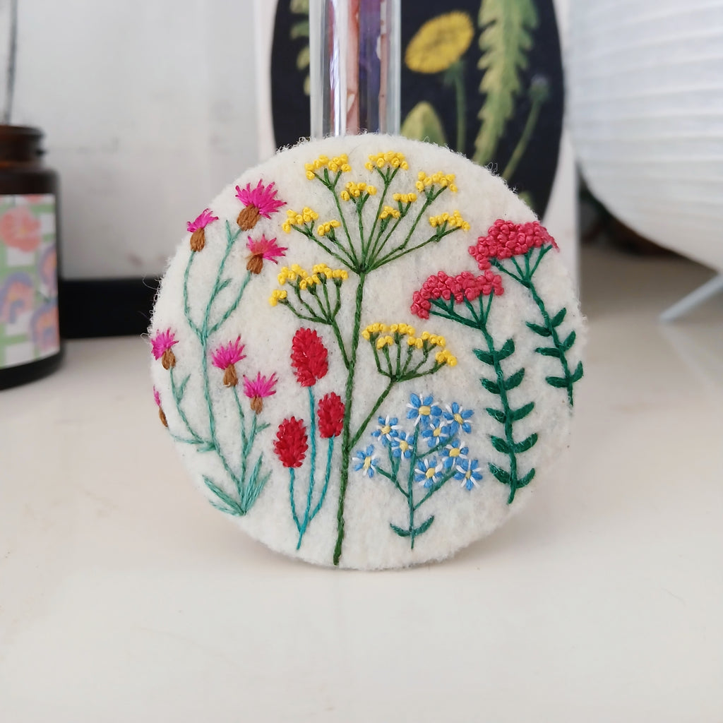 Brightly coloured floral badge