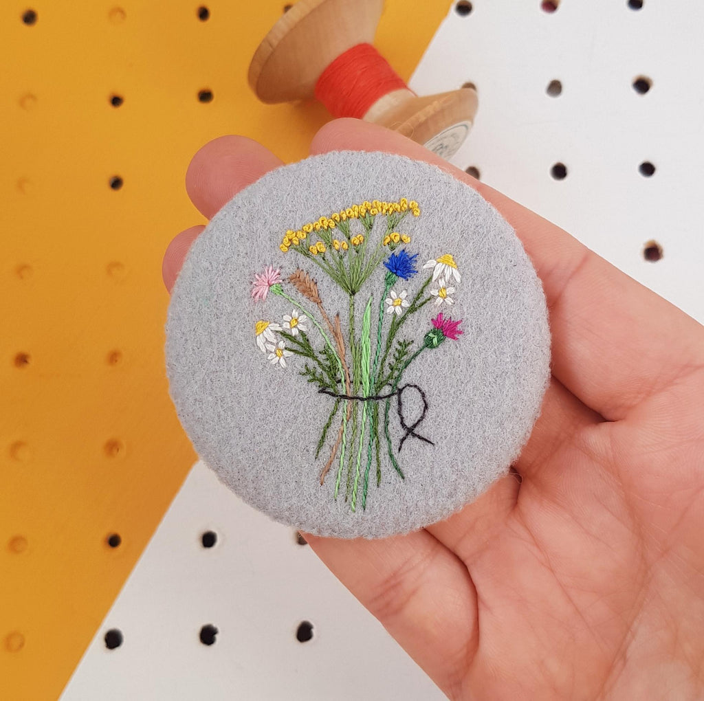 grey embroidered floral badge