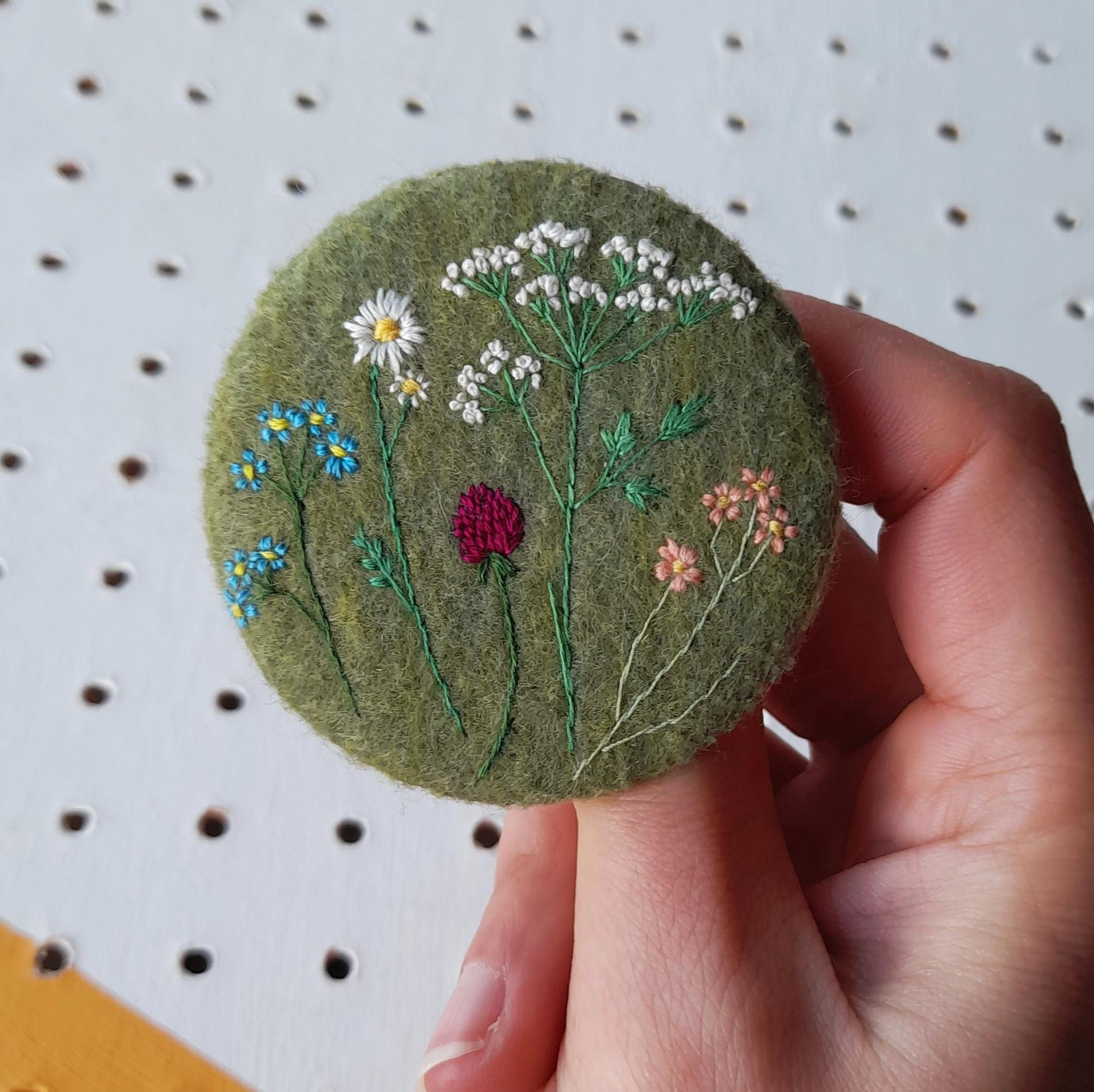 green wildflower badge