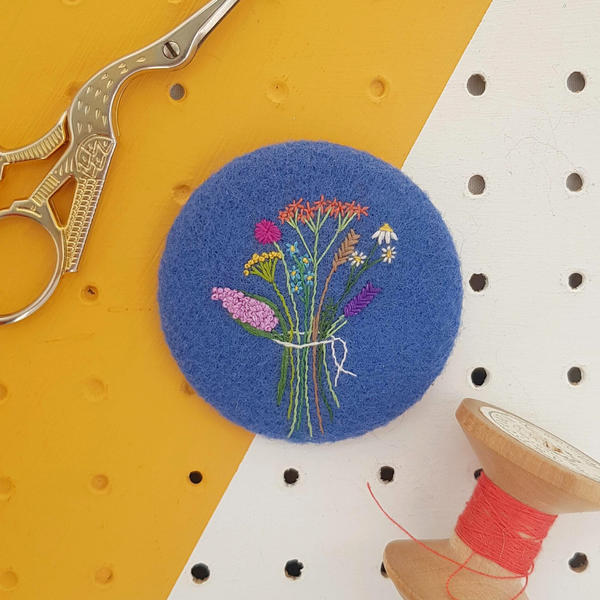 embroidered floral bouquet badge on blue