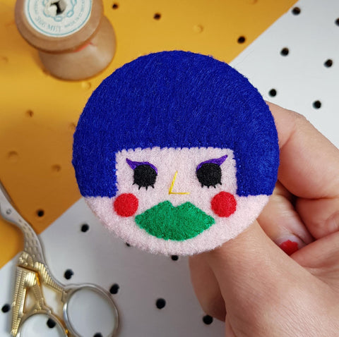 felt face badge with blue hair and green lips