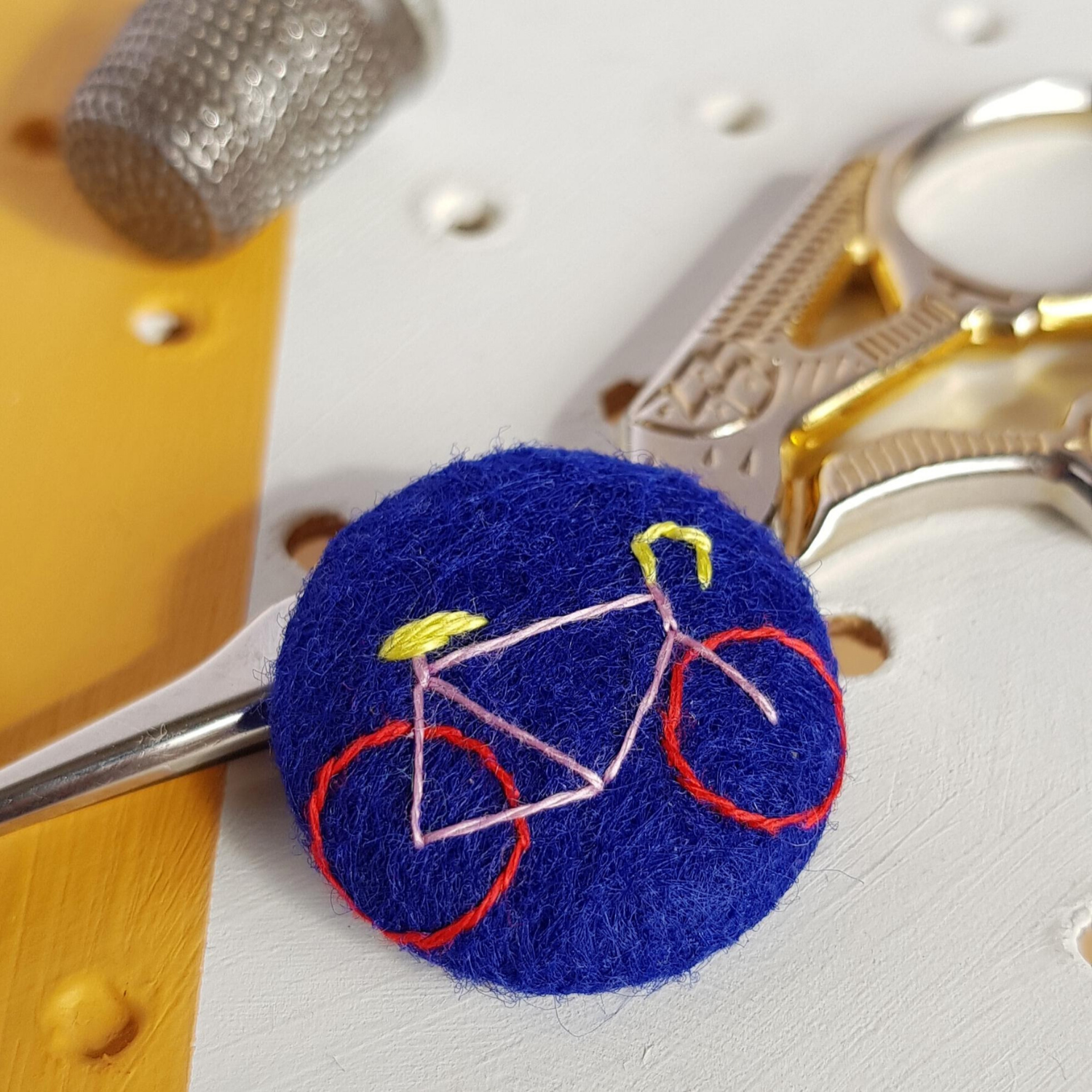embroidered bicycle on blue felt badge