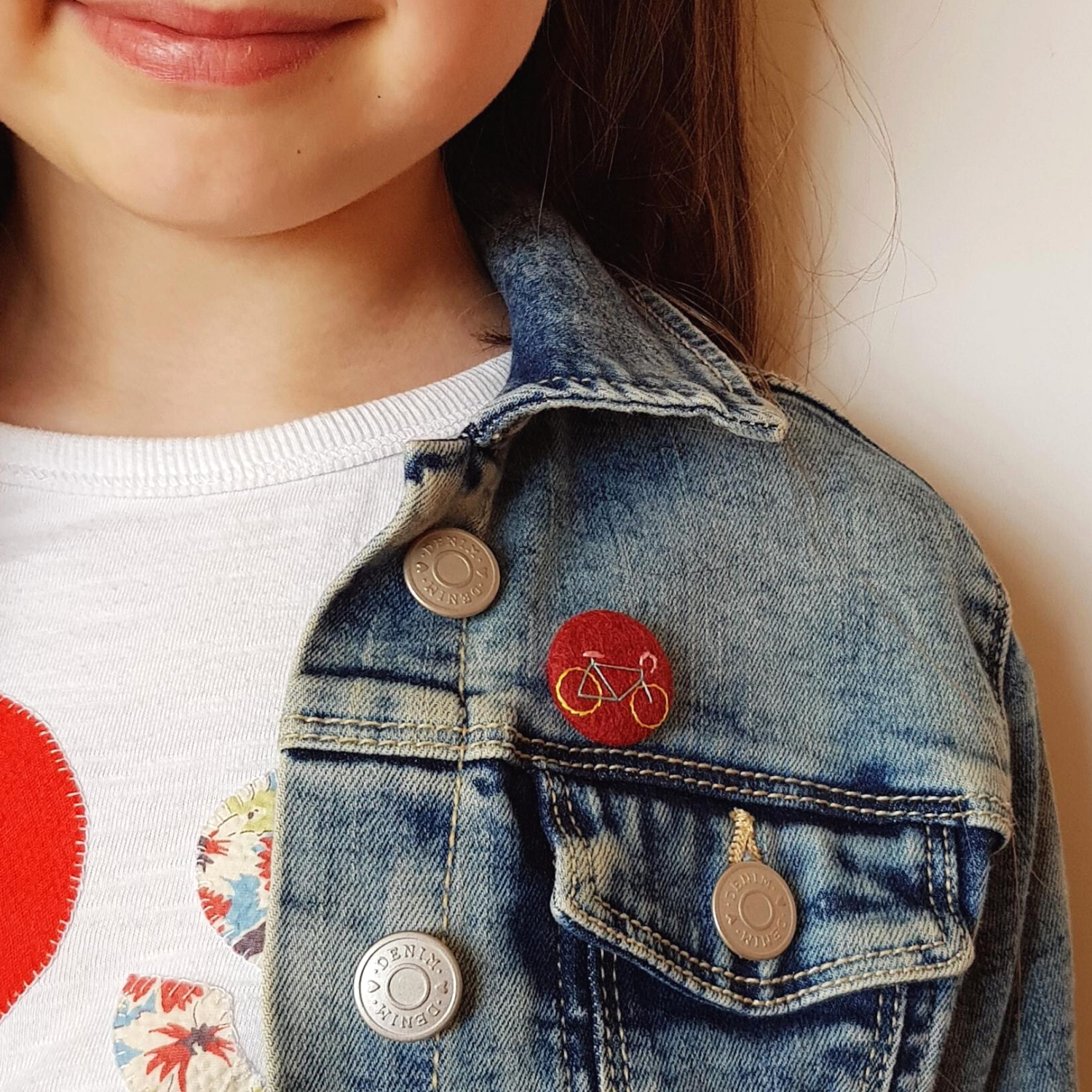burgundy bike badge - being worn