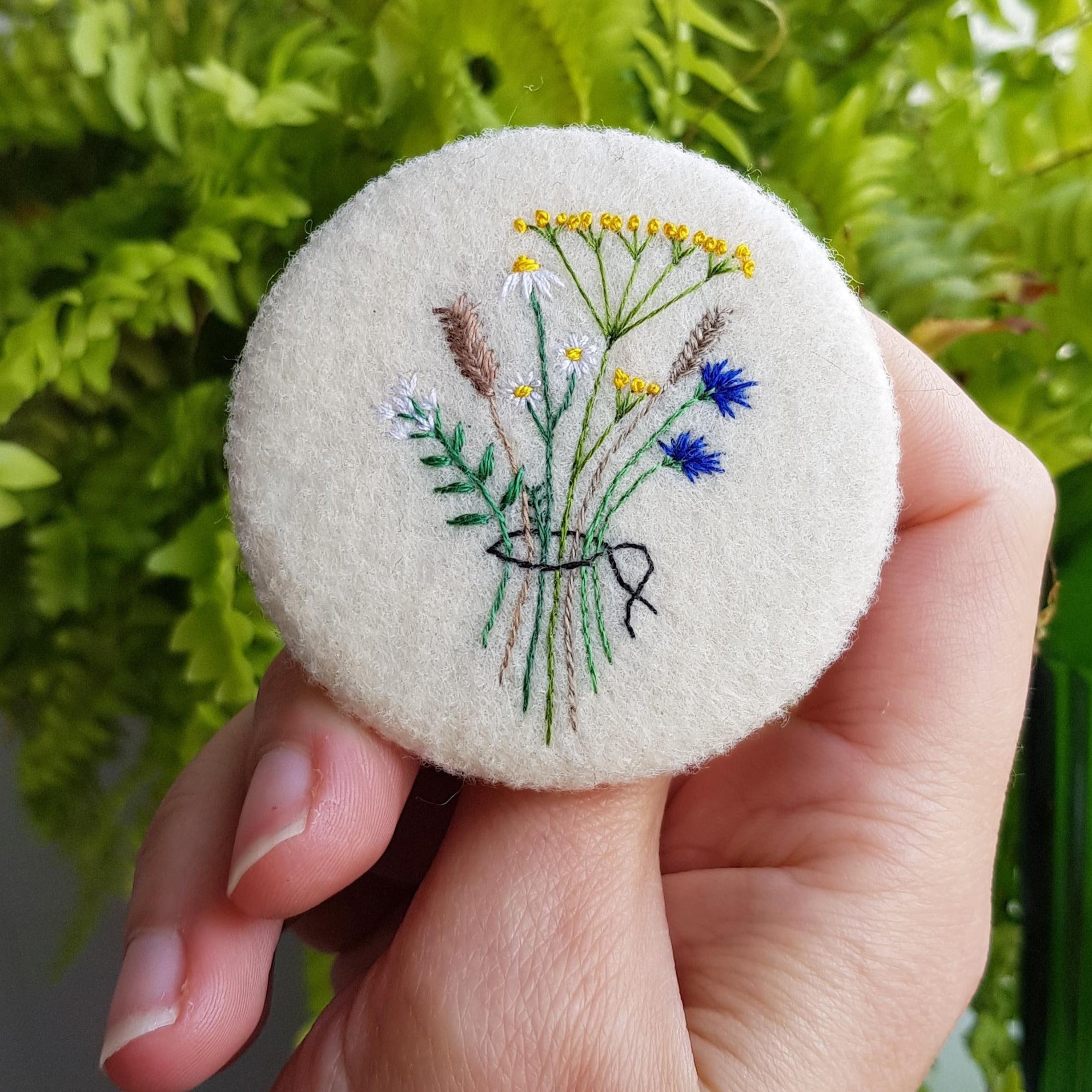 large felt badge with hand embroidered wild flowers