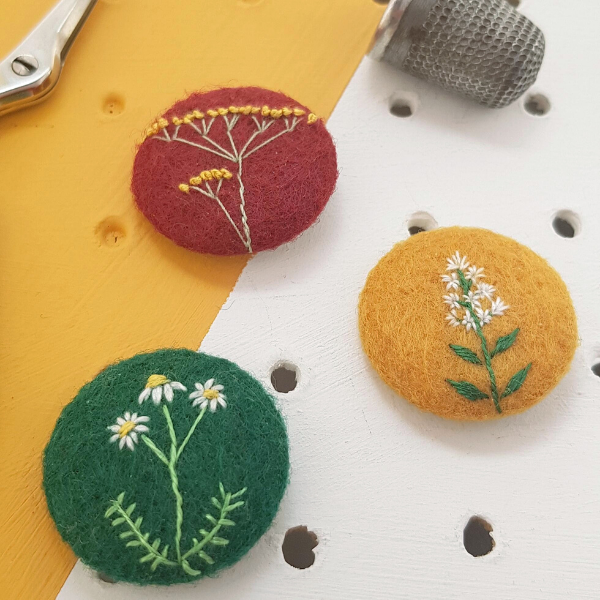 Close up of set of embroidered herb badges