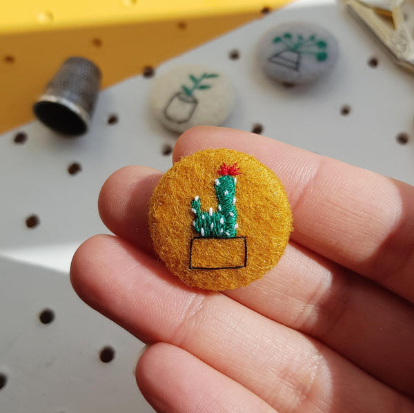 embroidered cactus badge on mustard yellow felt